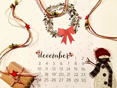 December calendar page decorated with festive ribbons, garland, parcel and snowman