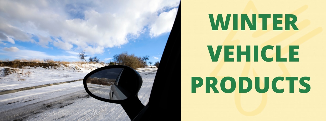 winter vehicle banner: rear view mirror of car reflecting snowy road on a bright day and text winter vehicle products