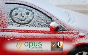 snowy car with smiley face drawn on window - Ferguson & Menzies winter vehicle care